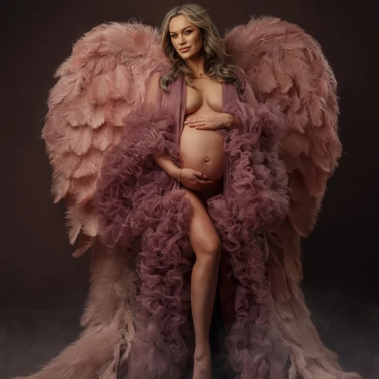 Maternity Photoshoot in North West London 31 Blush ruffled gown with soft pink wings; tender hands on belly.