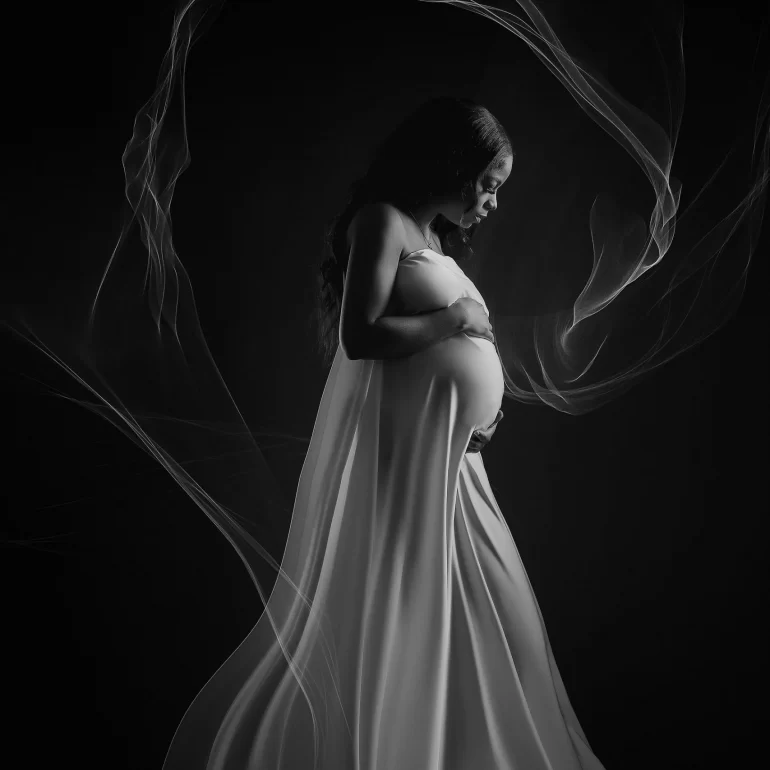 Maternity Photoshoot in North West London 46 B&W silky drape; delicate wisps circle serene profile.