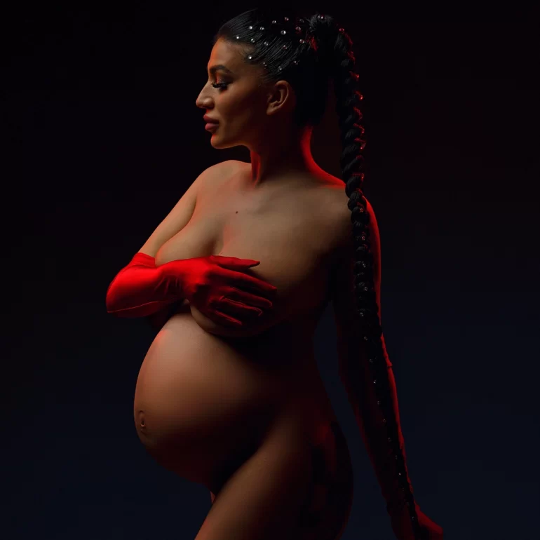 Maternity Photoshoot in North West London 32 Dramatic lighting; pearl‑dotted braid and single red glove; bold profile.