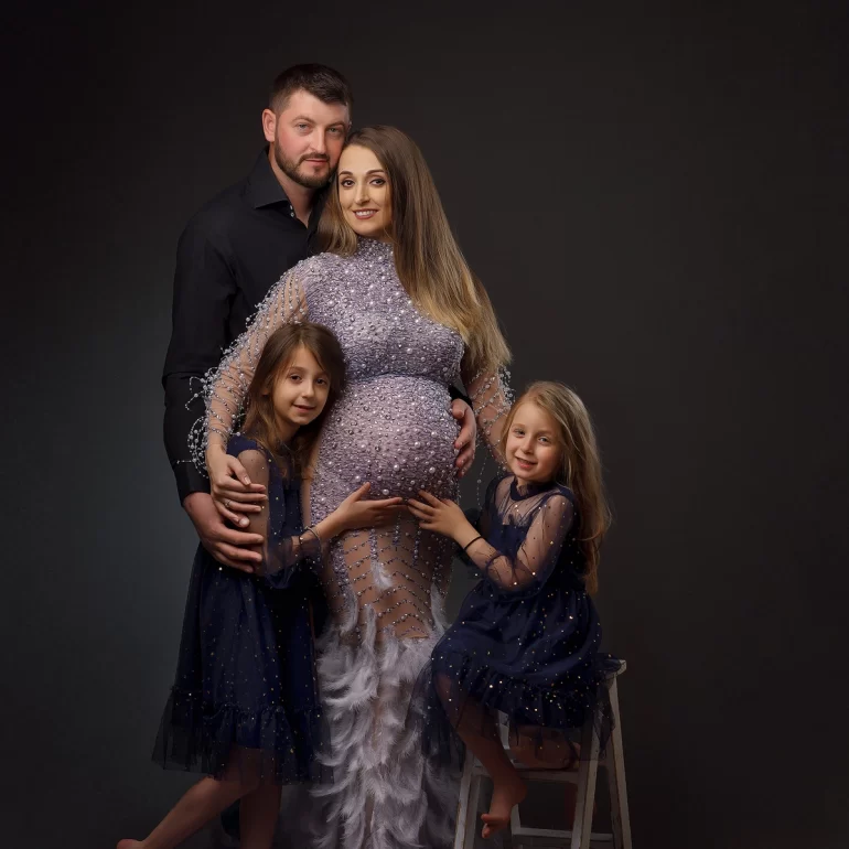 Maternity Photoshoot in North West London 33 Family portrait: glamorous gown with pearls and feathers; joyful togetherness.