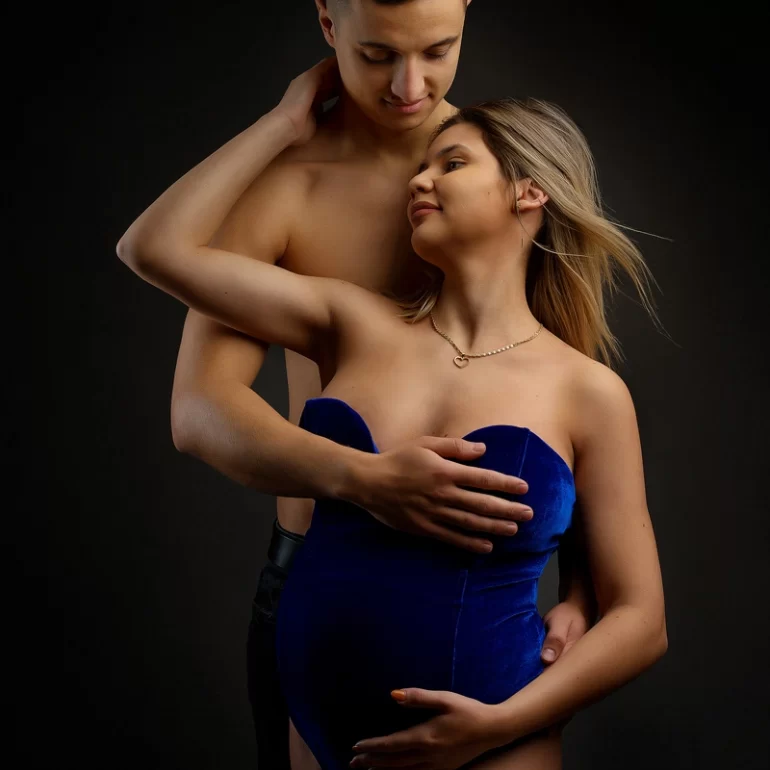 Maternity Photoshoot in North West London 36 Blue velvet bodysuit; partner’s gentle embrace; warm anticipation.