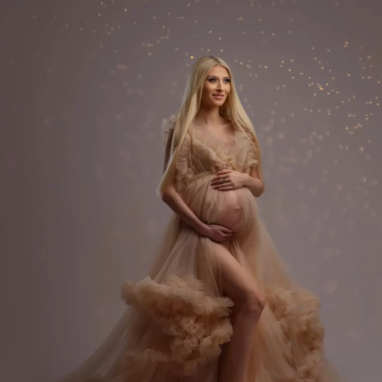 Maternity Photoshoot in North West London 41 Beige ruffled gown with golden light halo; warm, elegant portrait.