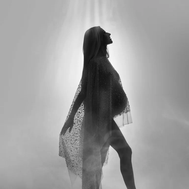 Maternity Photoshoot in North West London 48 Backlit silhouette in shimmering sheer fabric; divine, misty glow.