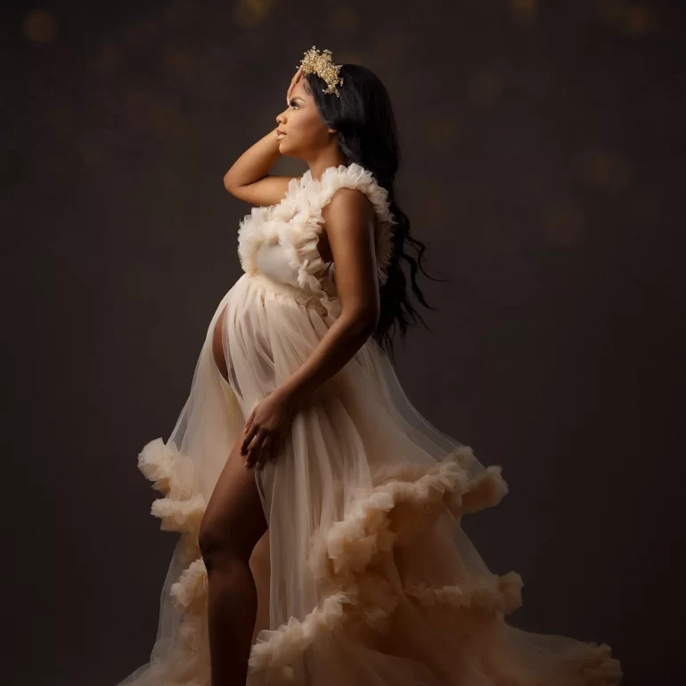 Maternity Photoshoot in North West London 56 Profile in layered beige ruffles; delicate gold crown; warm bokeh.