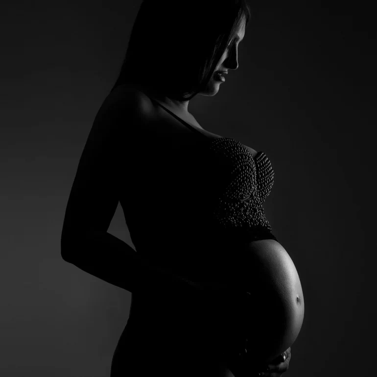 Maternity Photoshoot in North West London 61 B&W profile; soft light emphasizes the curve; textured top.