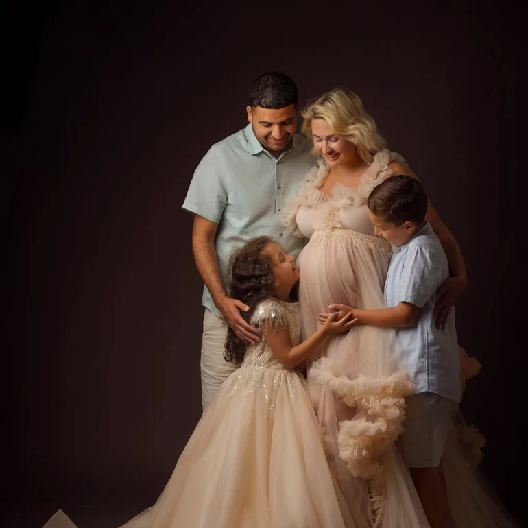 Maternity Photoshoot in North West London 60 Family celebration; peach ruffled gown; warm smiles and togetherness.