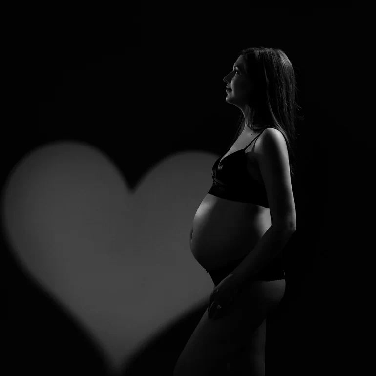 Maternity Photoshoot in North West London 63 Minimal B&W; simple outfit; heart‑shaped backlight; intimate mood.
