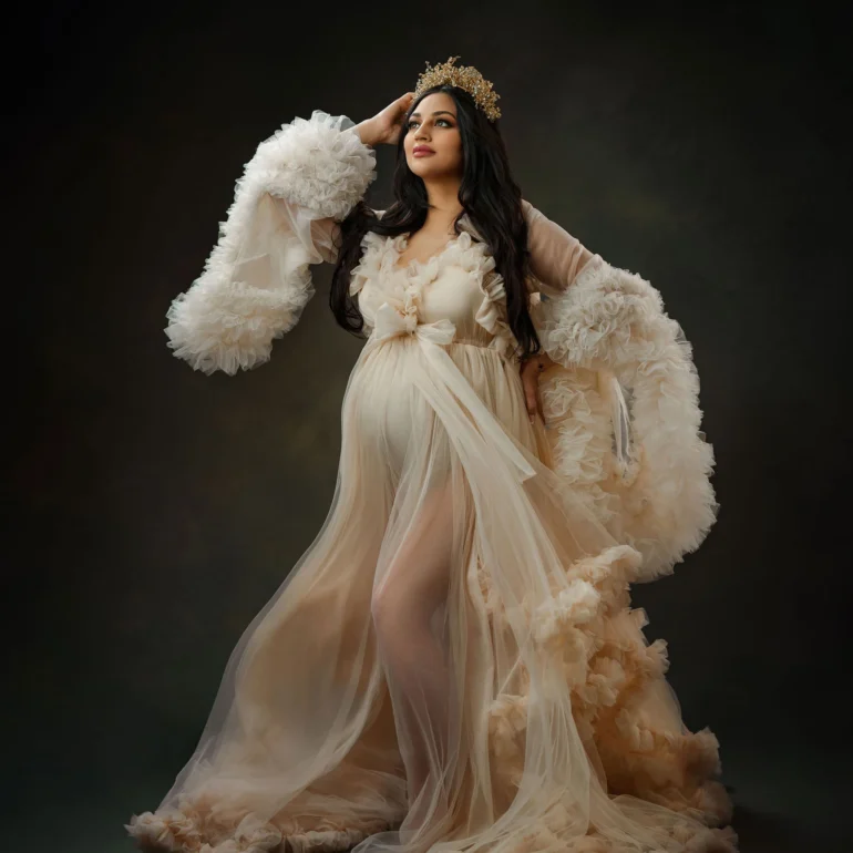 Maternity Photoshoot in North West London 84 Sheer cream gown and golden crown; softly lit, enchanting pose.