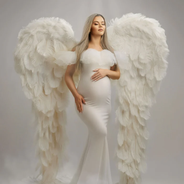 Maternity Photoshoot in North West London 83 Sleek white gown and white feathered wings; glowing white backdrop.