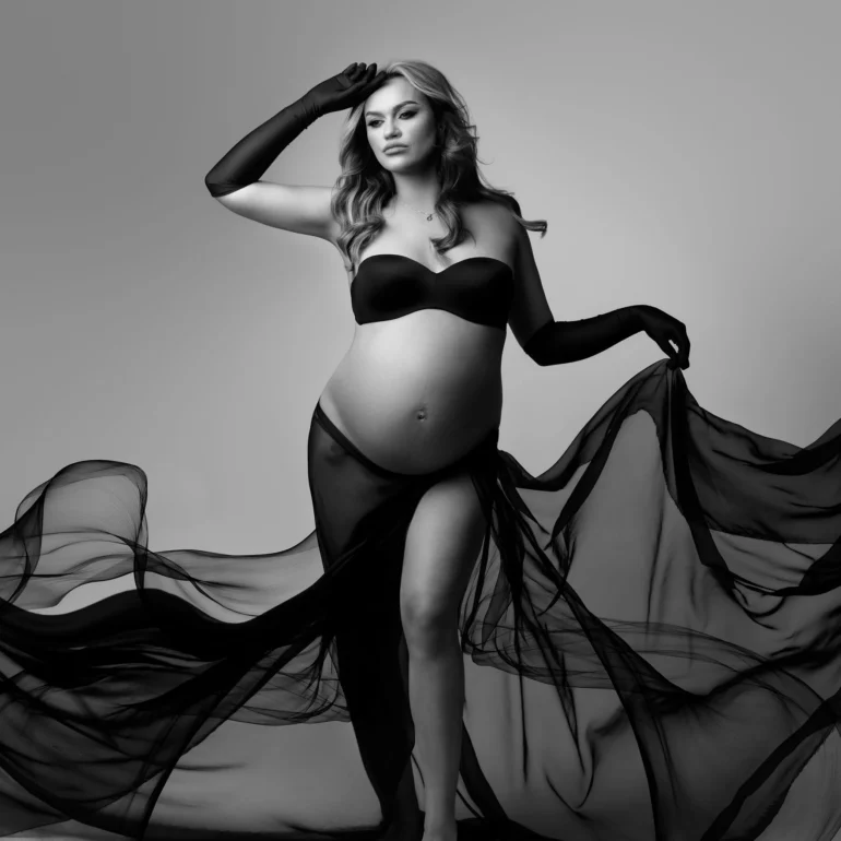 Maternity Photoshoot in North West London 88 B&W studio portrait; black bandeau and cascading sheer fabric; strong lines.