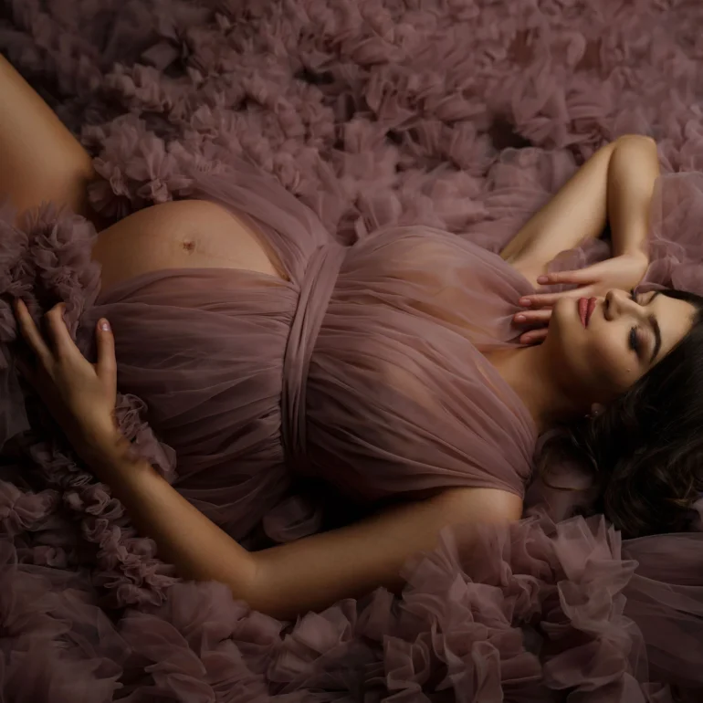 Maternity Photoshoot in North West London 75 Reclining on mauve ruffles; closed eyes; tranquil, intimate light.