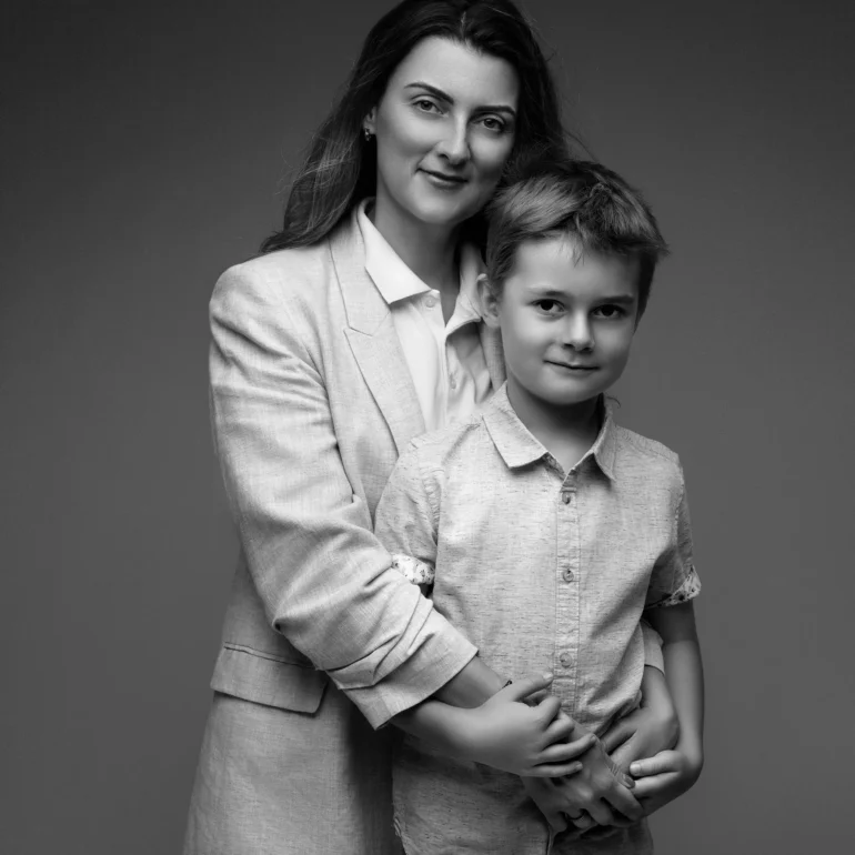 Family & Portrait Photoshoot in North West London 57 Mother embracing young son in smart casual attire; neutral black‑and‑white studio.
