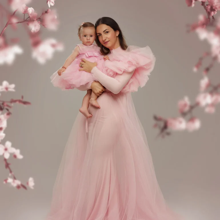 Family & Portrait Photoshoot in North West London 51 Mother and daughter in pink among soft cherry blossom branches; studio portrait.